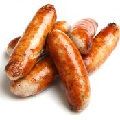 Cooked sausage piled together with a white background